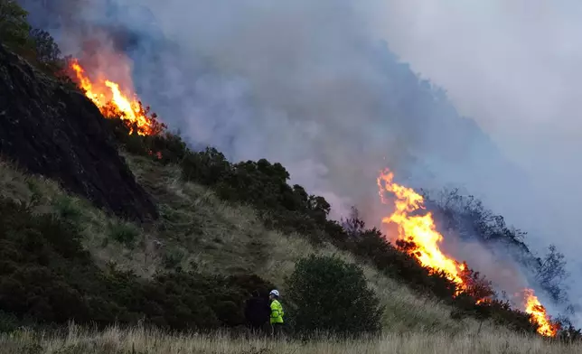 A view of a fire on Arthur's Seat in Holyrood Park, in Edinburgh, Scotland, Sunday, Aug. 10, 2025. (Jane Barlow/PA via AP)