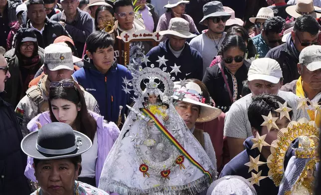 Devotees take part in a procession to honor Virgin of Copacabana, the patroness of Bolivia, in Copacabana, Bolivia, Tuesday, Aug. 5, 2025. (AP Photo/Juan Karita)