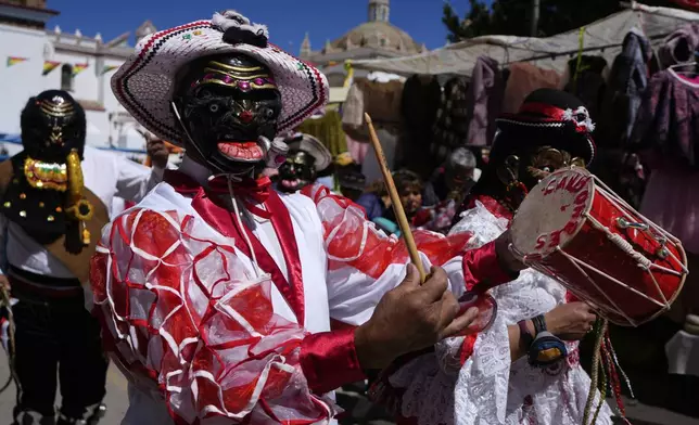 Dancers perform during a religious procession honoring Bolivia's patroness, the Virgin of Copacabana, in Copacabana, Bolivia, Tuesday, Aug. 5, 2025. (AP Photo/Juan Karita)