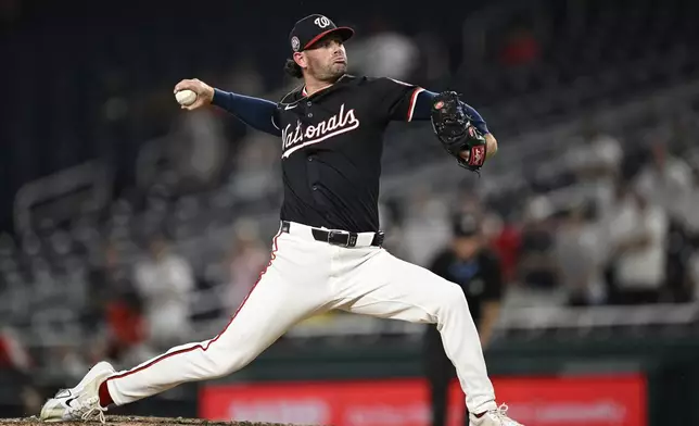 Washington Nationals pitcher Kyle Finnegan throws during the ninth inning of a baseball game against the Cincinnati Reds in Washington, Monday, July 21, 2025. (AP Photo/Terrance Williams)