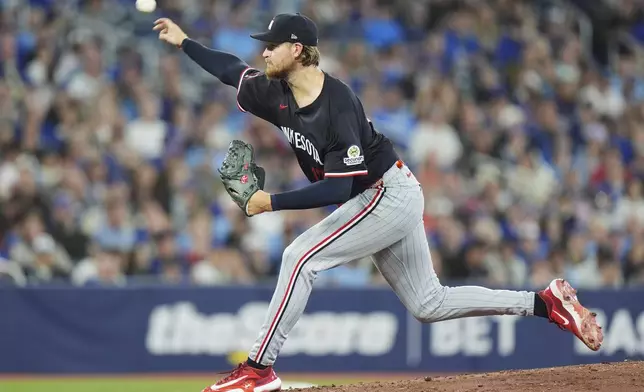 Minnesota Twins pitcher Bailey Ober works against the Toronto Blue Jays during the first inning of a baseball game in Toronto on Tuesday, Aug. 26, 2025. (Frank Gunn/The Canadian Press via AP)