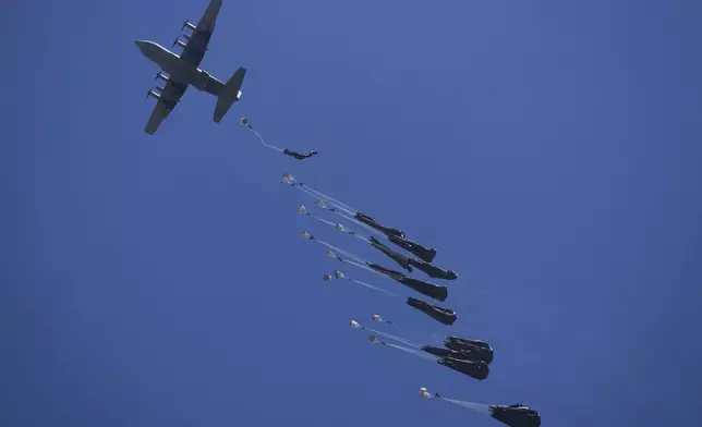 Humanitarian aid is airdropped to Palestinians over Deir al-Balah, central Gaza Strip, Tuesday, Aug. 5, 2025. (AP Photo/Abdel Kareem Hana)