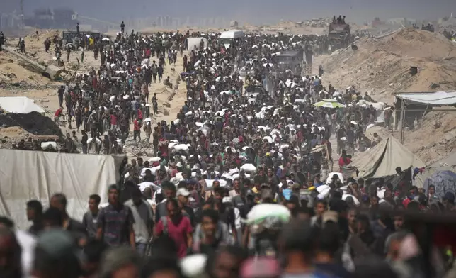 FILE - Palestinians carry sacks of flour taken from a humanitarian aid convoy in the outskirts of Beit Lahiya, northern Gaza Strip, Aug. 1, 2025. (AP Photo/Jehad Alshrafi, File)