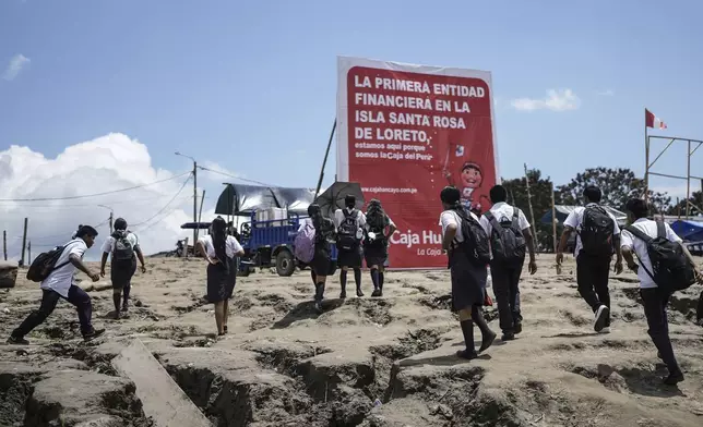 Students arrive in Santa Rosa, Peru, where they attend school, after crossing the Amazon River from Tabatinga, Brazil, Monday, Aug. 18, 2025. (AP Photo/Ivan Valencia)