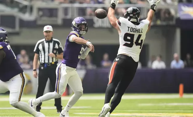 Houston Texans defensive end Casey Toohill (94) blocks a pass from Minnesota Vikings quarterback J.J. McCarthy during the first half of an NFL preseason football game, Saturday, Aug. 9, 2025, in Minneapolis. (AP Photo/Abbie Parr)