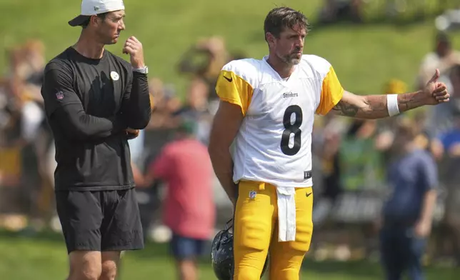 Pittsburgh Steelers quarterback Aaron Rodgers (8) and quarterback coach Tom Arth watch a drill during NFL football training camp in Latrobe, Pa., Wednesday, July 30, 2025. (AP Photo/Gene J. Puskar)