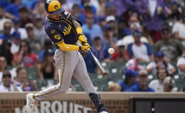 Milwaukee Brewers' Joey Ortiz hits a one-run single during the eighth inning of the first baseball game of a split doubleheader against the Chicago Cubs, Monday, Aug. 18, 2025, in Chicago. (AP Photo/Erin Hooley)