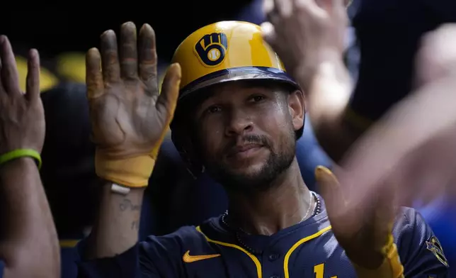 Milwaukee Brewers' Blake Perkins celebrates after scoring on a single hit by Joey Ortiz during the eighth inning of the first baseball game of a split doubleheader against the Chicago Cubs, Monday, Aug. 18, 2025, in Chicago. (AP Photo/Erin Hooley)