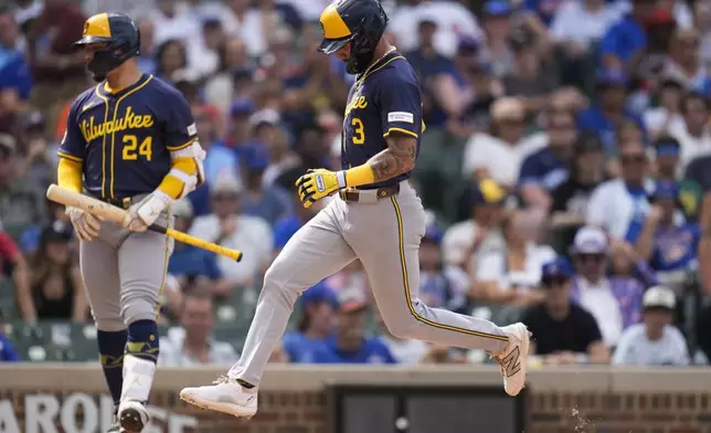 Milwaukee Brewers' Joey Ortiz (3) scores a wild pitch from Chicago Cubs pitcher Gavin Hollowell (not shown) during the eighth inning of the first baseball game of a split doubleheader Monday, Aug. 18, 2025, in Chicago. (AP Photo/Erin Hooley)