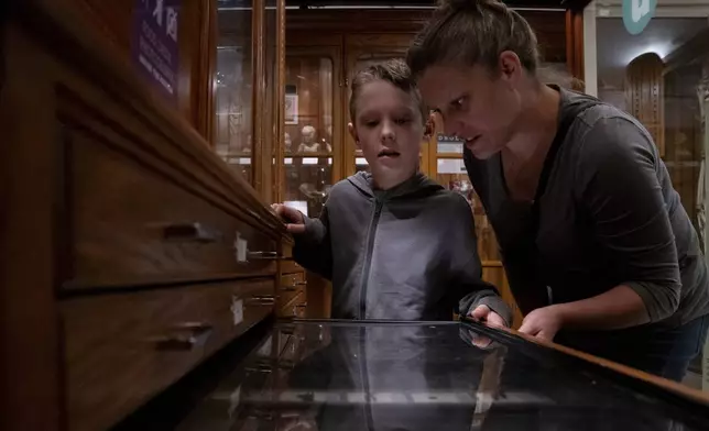 Lincoln Stollenwerk, 8, and Felice Leibowitz, 43, look at a display on objects swallowed by people at the Mütter Museum on Thursday, Aug. 21, 2025, in Philadelphia. (AP Photo/Mingson Lau)