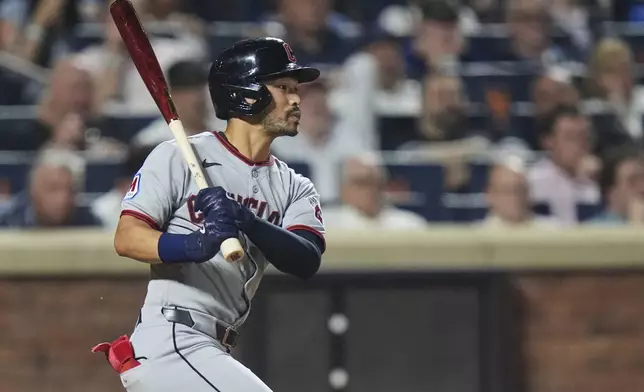 Cleveland Guardians' Steven Kwan follows through on an RBI single during the seventh inning of a baseball game against the New York Mets Tuesday, Aug. 5, 2025, in New York. (AP Photo/Frank Franklin II)