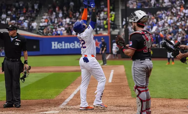 New York Mets' Juan Soto (22) celebrates after hitting a home run during the ninth inning of a baseball game against the Cleveland Guardians, Wednesday, Aug. 6, 2025, in New York. (AP Photo/Yuki Iwamura)