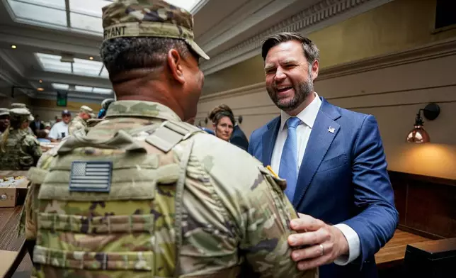Vice President JD Vance greets a member of the National Guard at Union Station in Washington, Wednesday, Aug. 20, 2025. (Alexander Drago/Pool via AP)