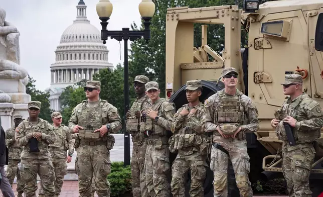 Protesters, police, and National Guard troops congregate at the entrance to Union Station in Washington, where Defense Secretary Pete Hegseth and Vice President JD Vance visited Wednesday, Aug. 20, 2025. (AP Photo/J. Scott Applewhite)