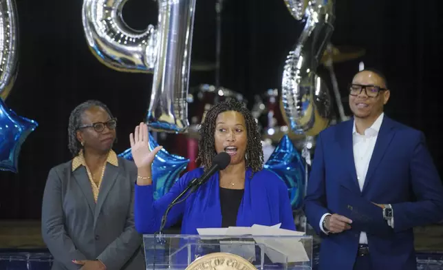 District of Columbia Mayor Muriel Bowser, center, is joined by Dr. Antoinette S. Mitchell, State Superintendent of Education, left, and Dr. Lewis D. Ferebee, Chancellor, DC Public Schools, right, during a pep rally with education leaders and educators from across the "Education Hill" Cluster, to celebrate the fast-approaching start to the 2025-26 school year, at Phelps Architecture Construction and Engineering High School in Washington, Wednesday, Aug. 20, 2025. (AP Photo/Rod Lamkey, Jr.)