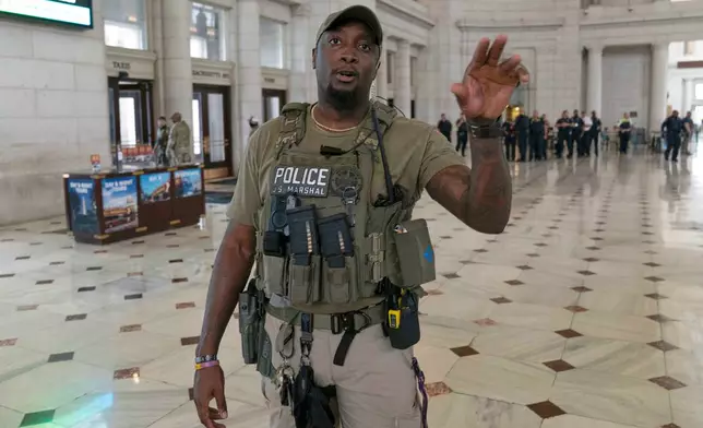 A U.S Marshal instructs media to stay back as Vice President JD Vance, Defense Secretary Pete Hegseth and White House Deputy Chief of Staff Stephen Miller visit with members of the National Guard at Union Station, in Washington Wednesday. Aug. 20, 2025. (AP Photo/Jose Luis Magana)