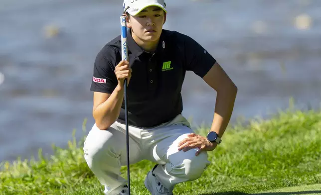 Akie Iwai of Japan lines up her putt on the 9th hole during the second round of the Canadian Women's Open golf tournament in Mississauga, Ont., Friday, Aug. 22, 2025. (Frank Gunn/The Canadian Press via AP)