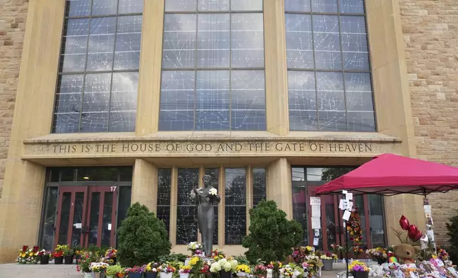 Items line a memorial at Annunciation Catholic Church after Wednesday's school shooting, Thursday, Aug. 28, 2025, in Minneapolis. (AP Photo/Abbie Parr)
