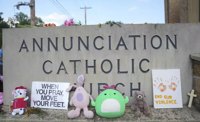 Items are left at a memorial at Annunciation Catholic Church after Wednesday's school shooting, Thursday, Aug. 28, 2025, in Minneapolis. (AP Photo/Abbie Parr)