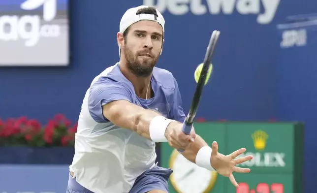 Karen Khachanov, of Russia, hits a return to Alexander Zverev, of Germany, during semifinal tennis action at the National Bank Open in Toronto on Wednesday, Aug., 6, 2025. (Chris Young/The Canadian Press via AP)