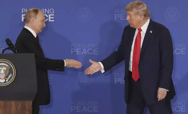 President Donald Trump, right, walks to shake the hand of Russia's President Vladimir Putin during a joint press conference at Joint Base Elmendorf-Richardson, Alaska, Friday, Aug. 15, 2025. (AP Photo/Jae C. Hong)