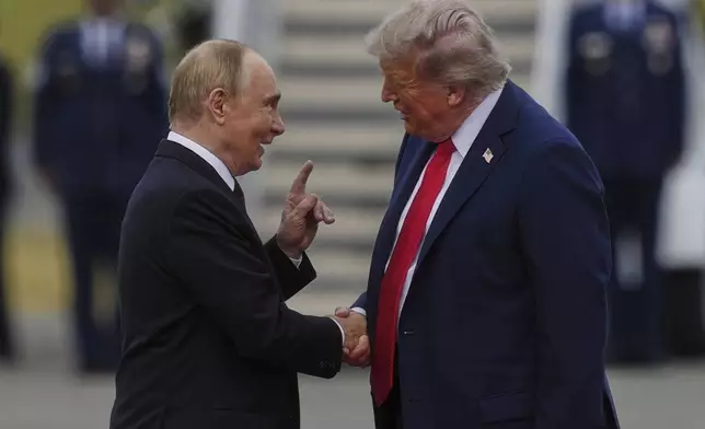 President Donald Trump greets Russia's President Vladimir Putin Friday, Aug. 15, 2025, at Joint Base Elmendorf-Richardson, Alaska. (AP Photo/Julia Demaree Nikhinson)