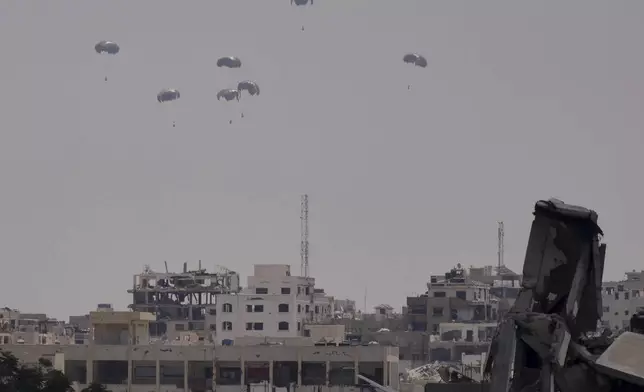 Humanitarian aid is airdropped to Palestinians over Gaza City, northern Gaza Strip, Friday, Aug. 8, 2025. (AP Photo/Jehad Alshrafi)