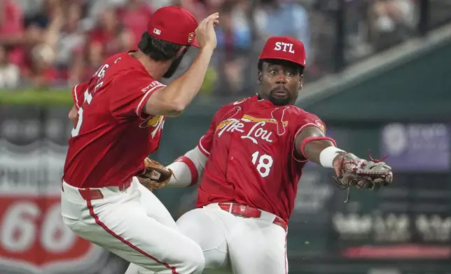 St. Louis Cardinals right fielder Jordan Walker, right, catches a fly ball by New York Yankees' Jasson Dominguez as Thomas Saggese, left, watches during the sixth inning of a baseball game Friday, Aug. 15, 2025, in St. Louis. (AP Photo/Jeff Roberson)
