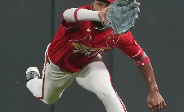 St. Louis Cardinals center fielder Victor Scott II reaches out and catches a fly ball by New York Yankees' Anthony Volpe during the eighth inning of a baseball game Friday, Aug. 15, 2025, in St. Louis. (AP Photo/Jeff Roberson)