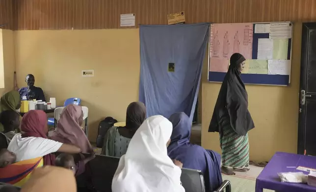 Falmata Muhammed, who once lost her pregnancy, leaves after a checkup at a facility run by aid group International Rescue Committee, in Magumeri, in northeast Nigeria's Borno state, Tuesday, July 22, 2025. (AP Photo/Sunday Alamba)