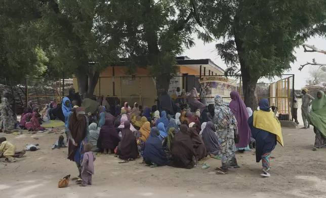 Women waits to be attended to at a facility run by aid group International Rescue Committee, in Magumeri, in northeast Nigeria's Borno state, Tuesday, July 22, 2025. (AP Photo/Sunday Alamba)