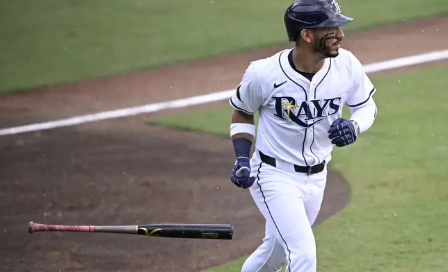 Tampa Bay Rays' José Caballero watches the flight of the ball after flying out during the seventh inning of a baseball game against the Baltimore Orioles, Sunday, July 20, 2025, in Tampa, Fla. (AP Photo/Phelan M. Ebenhack)