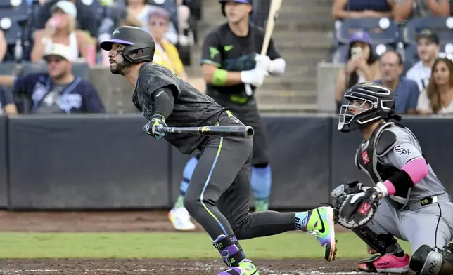 Tampa Bay Rays' José Caballero singles during the second inning of a baseball game against the Chicago White Sox Tuesday, July 22, 2025, in Tampa, Fla. (AP Photo/Jason Behnken)