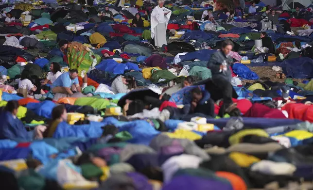Young people wake up after spending the night at the Tor Vergata field in Rome as they participate in the Youths Jubilee, Sunday, Aug. 3, 2025. (AP Photo/Andrew Medichini)