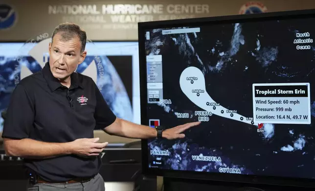Jamie Rhome, deputy director of the National Hurricane Center, gives an update on Tropical Storm Erin at the National Hurricane Center, Thursday, Aug. 14, 2025, in Miami. (AP Photo/Lynne Sladky)