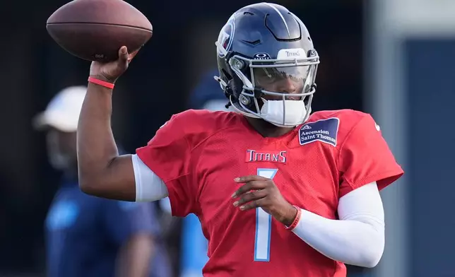 FILE - Tennessee Titans quarterback Cam Ward (1) looks to throw a pass during practice at the team's NFL football training camp Wednesday, July 30, 2025, in Nashville, Tenn. (AP Photo/George Walker IV, File)