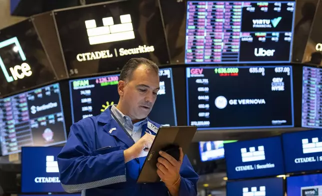 A Trader works on the floor of the New York Stock Exchange, Friday, Aug. 1, 2025, in New York. (AP Photo/Yuki Iwamura)