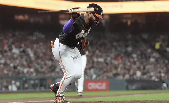 San Francisco Giants' Heliot Ramos throws his bat after popping out against the San Diego Padres during the sixth inning of a baseball game in San Francisco, Tuesday, Aug. 12, 2025. (AP Photo/Jeff Chiu)