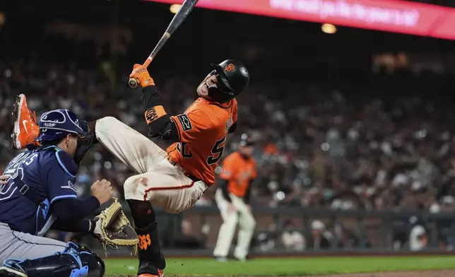 San Francisco Giants' Christian Koss, right, reacts next to Tampa Bay Rays catcher Nick Fortes after being hit by a pitch during the eighth inning of a baseball game Friday, Aug. 15, 2025, in San Francisco. (AP Photo/Godofredo A. Vásquez)