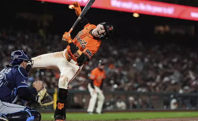 San Francisco Giants' Christian Koss, right, reacts next to Tampa Bay Rays catcher Nick Fortes after being hit by a pitch during the eighth inning of a baseball game Friday, Aug. 15, 2025, in San Francisco. (AP Photo/Godofredo A. Vásquez)