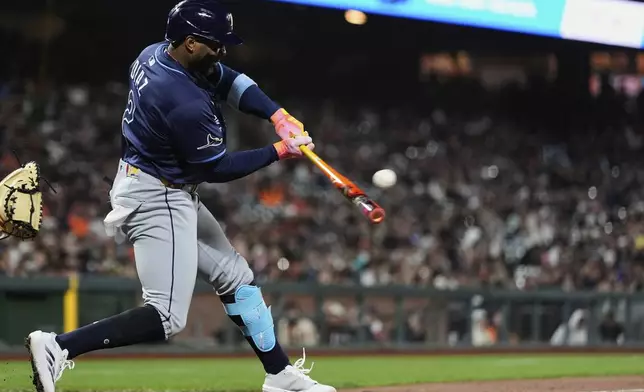 Tampa Bay Rays' Yandy Díaz hits an RBI single during the ninth inning of a baseball game against the San Francisco Giants, Friday, Aug. 15, 2025, in San Francisco. (AP Photo/Godofredo A. Vásquez)