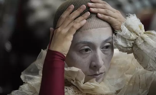 A circus performer prepares for Karandash-Fest, a street festival of ciscus performers in Staritsa, Tver region, Russia, Saturday, Aug. 2, 2025. (AP Photo/Pavel Bednyakov)