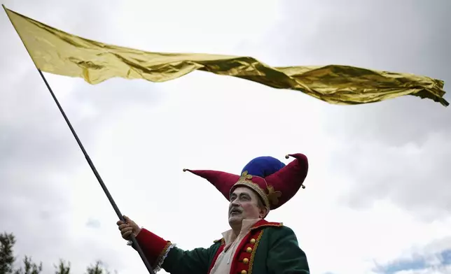A circus performer takes part in Karandash-Fest, a street festival of ciscus performers in Staritsa, Tver region, Russia, Saturday, Aug. 2, 2025. (AP Photo/Pavel Bednyakov)