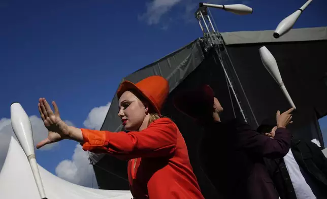 Circus performers warm up at the backstage of Karandash-Fest, a street festival of ciscus performers in Staritsa, Tver region, Russia, Saturday, Aug. 2, 2025. (AP Photo/Pavel Bednyakov)