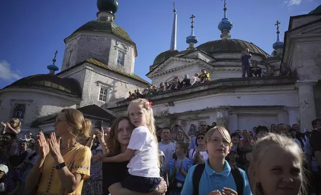 Spectators attend Karandash-Fest, a street festival of ciscus performers in Staritsa, Tver region, Russia, Saturday, Aug. 2, 2025. (AP Photo/Pavel Bednyakov)