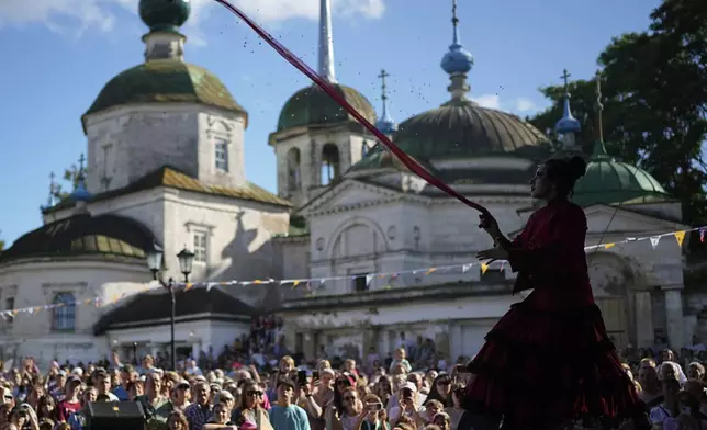 A circus performer takes part in Karandash-Fest, a street festival of ciscus performers in Staritsa, Tver region, Russia, Saturday, Aug. 2, 2025. (AP Photo/Pavel Bednyakov)
