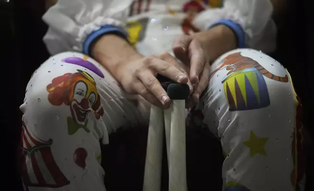 A circus performer prepares for Karandash-Fest, a street festival of ciscus performers in Staritsa, Tver region, Russia, Saturday, Aug. 2, 2025. (AP Photo/Pavel Bednyakov)