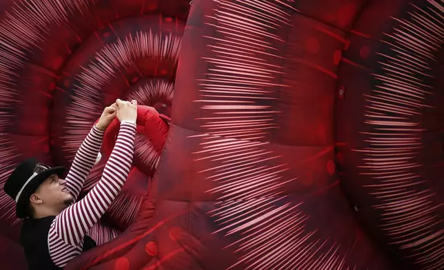 A circus performer prepares for Karandash-Fest, a street festival of ciscus performers in Staritsa, Tver region, Russia, Saturday, Aug. 2, 2025. (AP Photo/Pavel Bednyakov)