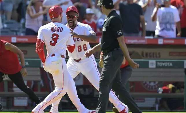 Los Angeles Angels' Taylor Ward (3) celebrates with third base coach Bo Porter (88) as he rounds the bases after hitting a three-run walkoff home run during the ninth inning of a baseball game against the Chicago White Sox, Sunday, Aug. 3, 2025, in Anaheim, Calif. (AP Photo/Jayne Kamin-Oncea)
