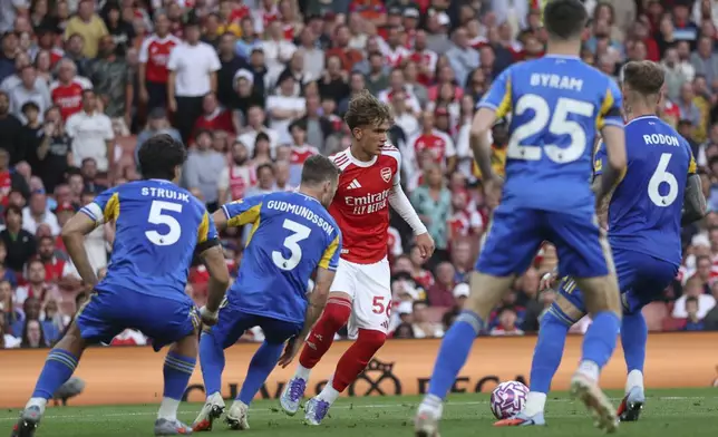 Arsenal's Max Dowman is closed down by the Leeds defence during the English Premier League soccer match between Arsenal and Leeds United at Emirates stadium in London, England, Saturday, Aug. 23, 2025. (AP Photo/Ian Walton)